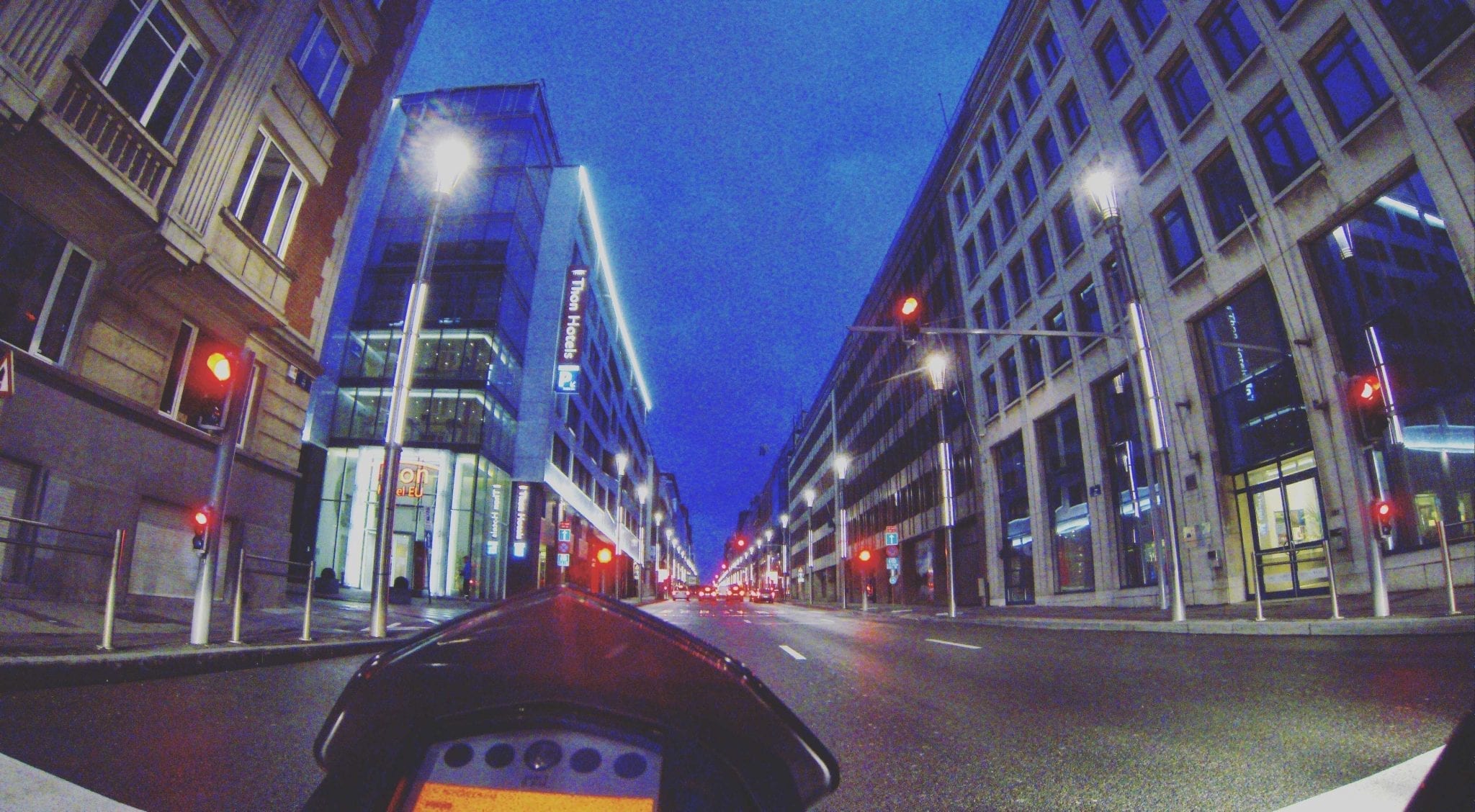 An advertising display on Facebook showcasing a motorcycle cruising through a city street after dark.