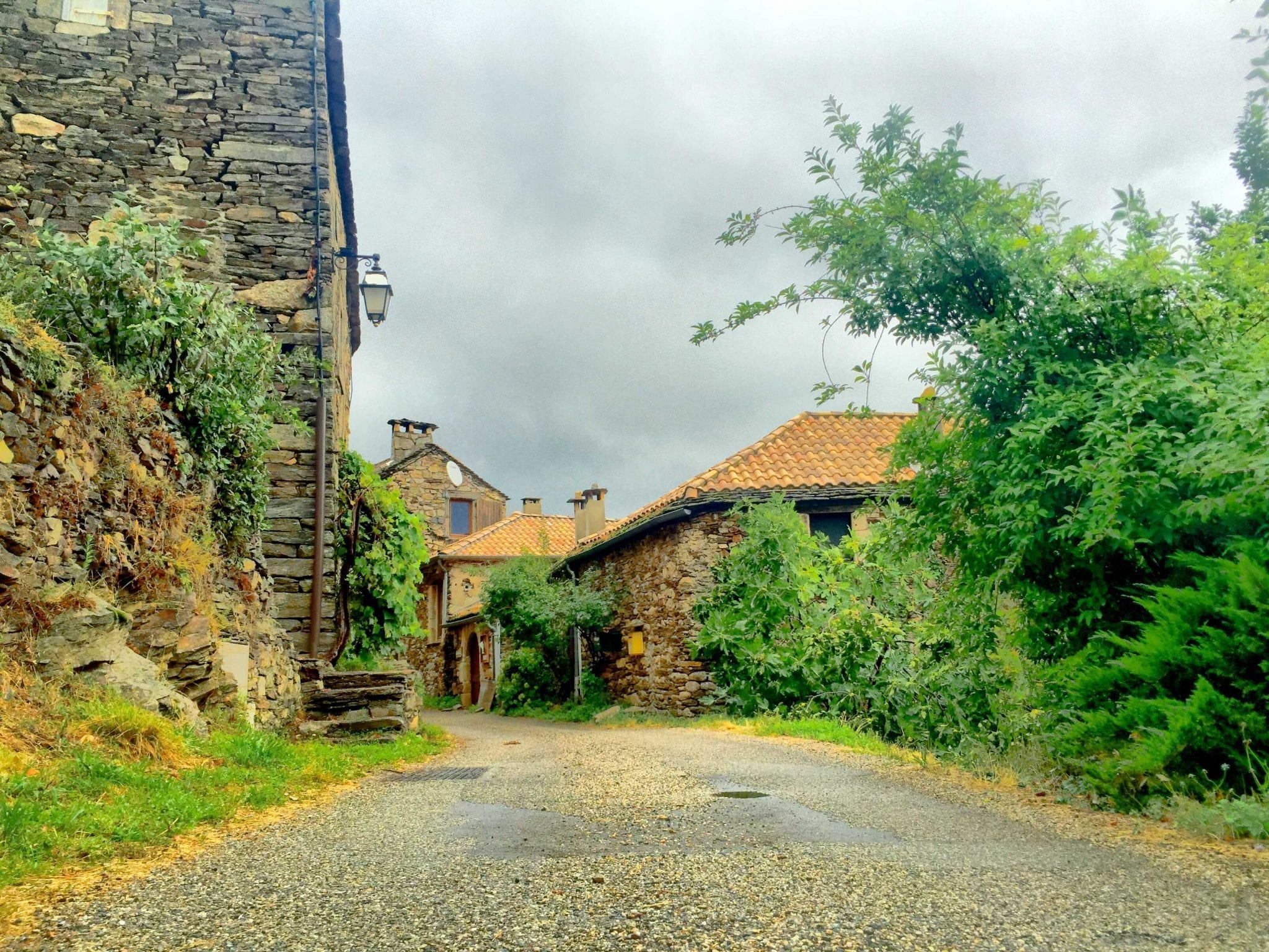 A stone road leading to an old stone house, featuring Sterling and Jay from Internet Business Mastery.
