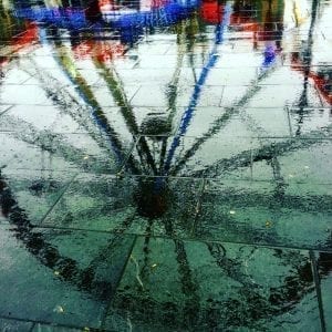 Ferris Wheel Reflected In A Puddle