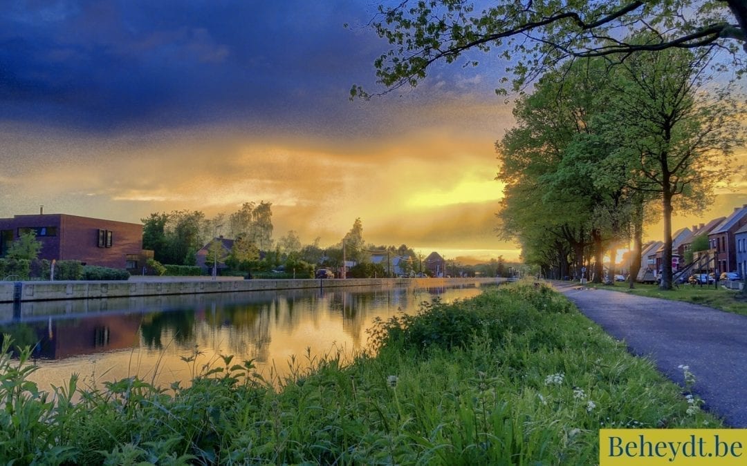 Colorful and dramatic sunrise or sunset over a Countryside river landscape seen from the riverside