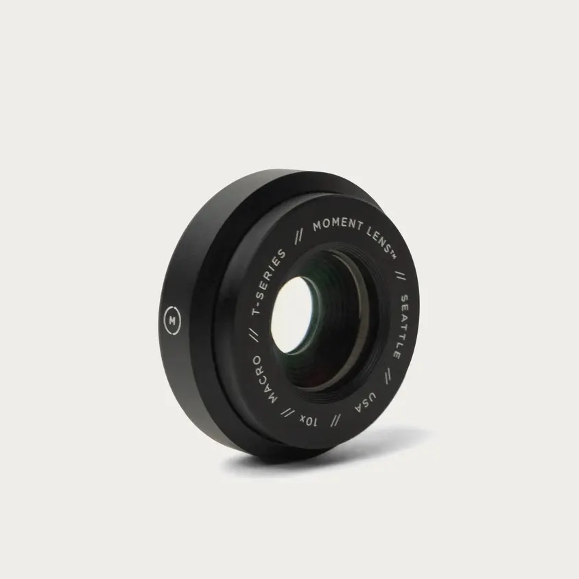 A black Moment lens on a white background, elevating mobile photography and filmmaking.